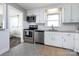 Well-lit kitchen features stainless steel appliances, white cabinets, and modern backsplash at 4837 Holbrook Dr, Charlotte, NC 28212