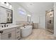 Luxurious bathroom featuring a freestanding tub, double vanity, and walk-in shower, designed for relaxation at 6124 Music Arbor Ln, Huntersville, NC 28078