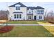 Beautiful two-story white brick home with a well-manicured lawn and appealing curb appeal at 6124 Music Arbor Ln, Huntersville, NC 28078