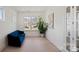 Bright room with a blue couch, big windows, and neutral walls at 6124 Music Arbor Ln, Huntersville, NC 28078