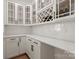 Pantry area with built-in wine racks and white cabinets at 6124 Music Arbor Ln, Huntersville, NC 28078