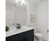 Elegant powder room with a navy vanity, quartz countertop, and modern fixtures at 6124 Music Arbor Ln, Huntersville, NC 28078