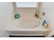 Clean bathroom with a bathtub, window, and updated vanity at 8244 Fox Swamp Rd, Charlotte, NC 28215