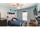 Bright bedroom with a double bed, desk, and ceiling fan at 8244 Fox Swamp Rd, Charlotte, NC 28215
