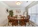 Formal dining room with wood table and chairs, decorative wall art, and window with blinds at 8244 Fox Swamp Rd, Charlotte, NC 28215
