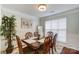 Formal dining room featuring a wood table and chairs, neutral walls, and a large window at 8244 Fox Swamp Rd, Charlotte, NC 28215
