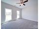 Bright bedroom with ceiling fan and plush carpeting. Features three large windows at 0000 Trull Hinson Rd, Wingate, NC 28174