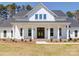 White farmhouse exterior with a wraparound porch and landscaping at 0000 Trull Hinson Rd, Wingate, NC 28174