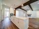 White kitchen island with quartz countertops and hardwood floors at 0000 Trull Hinson Rd, Wingate, NC 28174