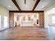 Open kitchen with white cabinets, a large island, and exposed wooden beams at 0000 Trull Hinson Rd, Wingate, NC 28174