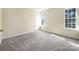 Bedroom with neutral walls and carpeting, featuring two windows at 11006 Renoir Ct, Charlotte, NC 28215