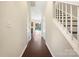 Bright entryway with hardwood floors, leading to the living area and stairs at 11006 Renoir Ct, Charlotte, NC 28215