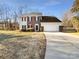 Two-story brick and vinyl sided home with attached garage and landscaping at 11006 Renoir Ct, Charlotte, NC 28215