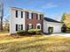 Two-story house front view, featuring brick and vinyl siding, and a double garage at 11006 Renoir Ct, Charlotte, NC 28215