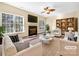 Virtually staged living room with fireplace and built-in shelving at 11006 Renoir Ct, Charlotte, NC 28215