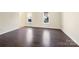 Spacious living room featuring hardwood floors and large windows at 11006 Renoir Ct, Charlotte, NC 28215