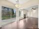 Sunroom with fireplace and sliding glass doors leading to backyard at 11006 Renoir Ct, Charlotte, NC 28215