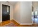 Light-colored hallway with dark door and wood floors at 1101 W 1St St # 405, Charlotte, NC 28202