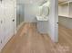 Spa-like bathroom with walk-in shower, double vanity, and hardwood floors at 1201 Pierson Dr, Charlotte, NC 28205