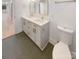 Double vanity bathroom with dark grey tile floors and updated fixtures at 1201 Pierson Dr, Charlotte, NC 28205