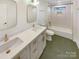 Main bathroom with double vanity, bathtub, and stylish tile at 1201 Pierson Dr, Charlotte, NC 28205