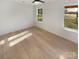 Light-filled bedroom featuring hardwood floors and two windows at 1201 Pierson Dr, Charlotte, NC 28205