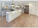 Modern kitchen with white cabinetry, quartz countertops, and a large island at 1201 Pierson Dr, Charlotte, NC 28205