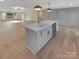 White kitchen island with a sink, dishwasher, and ample storage at 1201 Pierson Dr, Charlotte, NC 28205