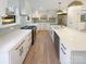 Modern kitchen with white cabinets, quartz countertops, and gold fixtures at 1201 Pierson Dr, Charlotte, NC 28205
