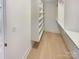 Spacious walk-in closet with built-in shelves and hanging rods at 1201 Pierson Dr, Charlotte, NC 28205