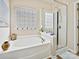 Relaxing bathroom with soaking tub, shower, and window at 1255 Tranquil Falls Ln, Matthews, NC 28104