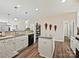 Open kitchen with island, granite counters, and white cabinets at 1255 Tranquil Falls Ln, Matthews, NC 28104