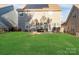 A spacious backyard with a patio, outdoor seating, and solar panels on the roof at 136 Margo Ln, Statesville, NC 28677