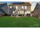 Backyard featuring a green lawn, patio, outdoor seating, and solar panels on the roof at 136 Margo Ln, Statesville, NC 28677