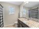 Bathroom featuring granite countertop, patterned shower curtain, and bright window at 136 Margo Ln, Statesville, NC 28677