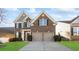 Beautiful two-story brick home featuring a two-car garage and manicured front lawn at 136 Margo Ln, Statesville, NC 28677