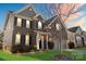 Attractive brick home with a manicured front lawn, and colorful sunset backdrop at 136 Margo Ln, Statesville, NC 28677