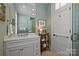 Elegant bathroom with white vanity and patterned wallpaper at 166 Iron Gate Cir, Mooresville, NC 28117