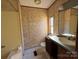 Bathroom with floral wallpaper, vanity, and tub at 181 Jeter St, Chester, SC 29706