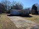 Mobile home with a long driveway and mature trees at 181 Jeter St, Chester, SC 29706