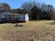 Blue mobile home with a large yard and storage shed at 181 Jeter St, Chester, SC 29706