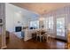 Kitchen features a dining area, white cabinets, and herringbone backsplash at 18225 Harbor Mist Rd, Cornelius, NC 28031