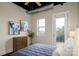 Spacious bedroom with a queen bed, balcony access, and artwork at 2338 Yadkin Ave # 203, Charlotte, NC 28205