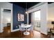 Modern condo dining area with white table and gray chairs near balcony and living room at 2338 Yadkin Ave # 203, Charlotte, NC 28205