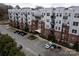 Modern building exterior with parking and landscaping at 2338 Yadkin Ave # 203, Charlotte, NC 28205
