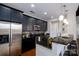 Modern kitchen with dark cabinetry, stainless steel appliances, and a large island at 2338 Yadkin Ave # 203, Charlotte, NC 28205