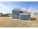 A spacious backyard with a newly built blue home and adjacent homes at 24078 Sailfish Dr # 1152, Lancaster, SC 29720