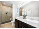 Modern bathroom featuring dual sinks, sleek vanity, and a tiled walk-in shower with glass door at 24078 Sailfish Dr # 1152, Lancaster, SC 29720