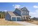 Beautiful blue two-story home with a two-car garage and stone accents at 24078 Sailfish Dr # 1152, Lancaster, SC 29720