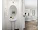 The powder room features a pedestal sink, oval mirror, and modern lighting at 24078 Sailfish Dr # 1152, Lancaster, SC 29720